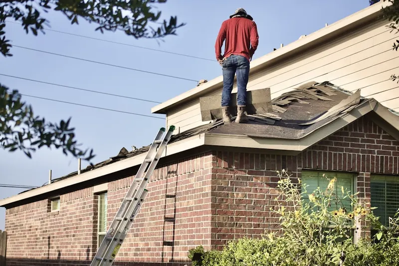Professional roofer working on a residential roof in Caln